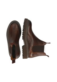 Botas de cuero marrón hasta el tobillo, con paneles laterales elásticos, suela de goma ranurada y lengüeta para facilitar su uso. Acabado texturizado con detalles brillantes.