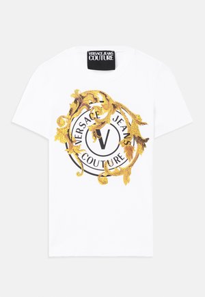 White cotton t-shirt featuring a round graphic with black and gold motifs, including a circular logo and decorative elements.
