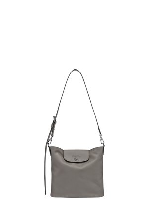 Gray leather crossbody bag with adjustable strap and flap closure featuring embossed logo and metallic snap button.