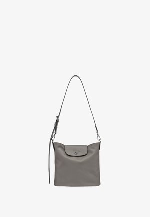 Gray leather crossbody bag with adjustable strap and flap closure featuring embossed logo and metallic snap button.