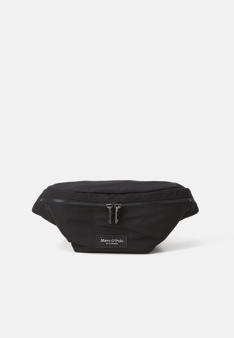 Black fabric fanny pack with a front zipper closure, rounded shape, and a small logo tag. Smooth texture and minimalistic design.
