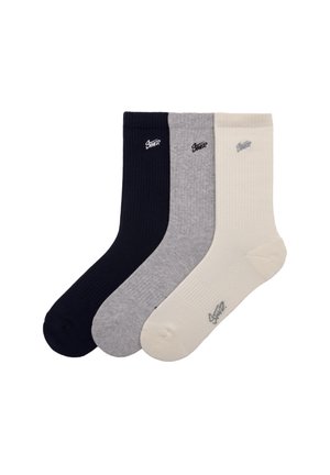 Tre paia di calzini a coste nei colori blu navy, grigio e crema. Ogni calzino presenta un piccolo logo sull'area della caviglia.