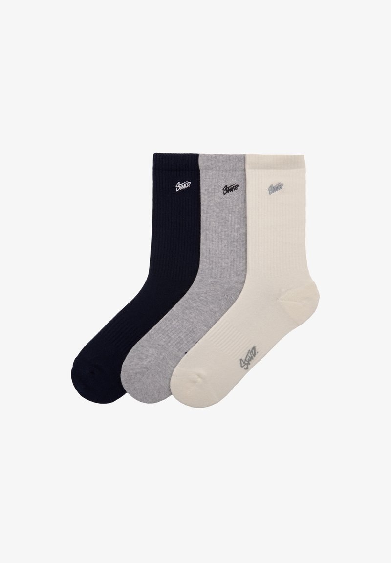 Tre paia di calzini a coste nei colori blu navy, grigio e crema. Ogni calzino presenta un piccolo logo sull'area della caviglia.