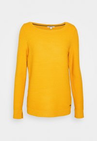 Pull jaune en maille avec un tissu texturé, col rond, manches longues et fentes latérales discrètes à l'ourlet. Étiquette de la marque en bas.