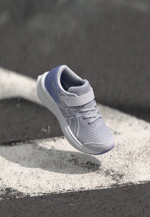 Light purple athletic shoe with mesh fabric, rubber sole, and strap. Features accent lines and a rounded toe design.