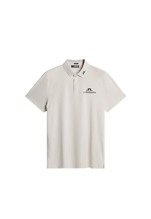 Light beige polo shirt with short sleeves, a collar, and a three-button placket. Features black logo on the chest and shoulder. Smooth texture.