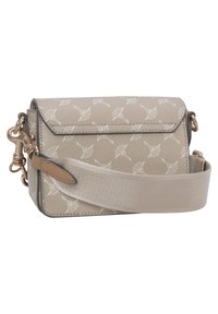 Beige crossbody taška z texturovaného materiálu, zdobená vzorem listů, s kovovými akcenty ve zlaté barvě a tkaným popruhem pro nastavitelnou délku.