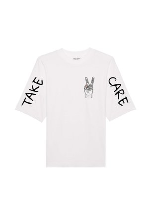 White t-shirt with short sleeves, featuring a black graphic of a hand making a peace sign and text reading "TAKE" and "CARE."