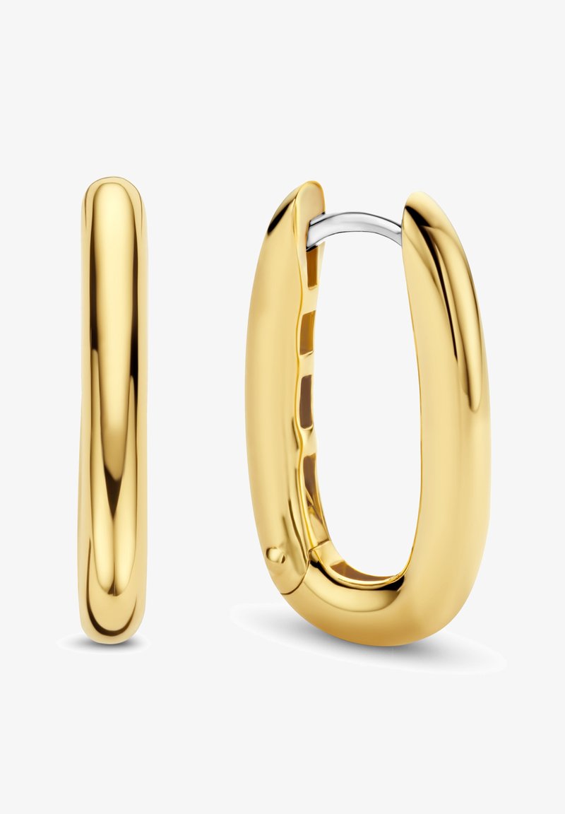 Goldene Creolen mit glänzender Oberfläche. Verfügen über ein glattes, abgerundetes Design und ein silbernes Metallscharnier für sicheren Verschluss.