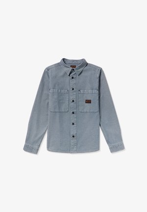 Long-sleeve, button-up shirt in light blue denim. Features two chest pockets, black buttons, and a label on the right pocket.