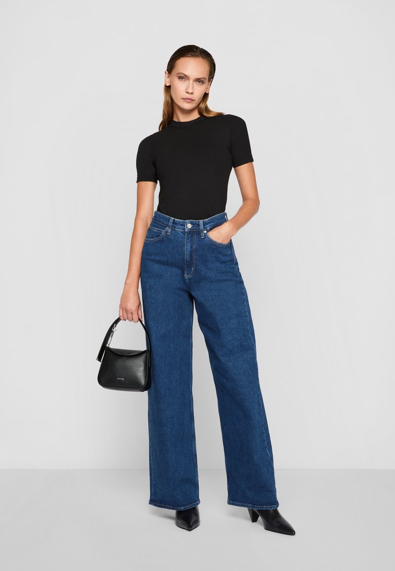 Calvin Klein WIDE STONE - Wide leg - denim dark