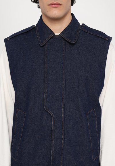 Denim vest in dark blue with contrasting orange stitching, featuring a collar, two front pockets, and a clean, streamlined design.