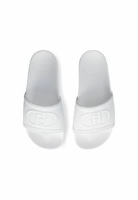 White slide sandals with a textured surface and embossed logo on the strap. Flat design, made of synthetic material, open toe style.