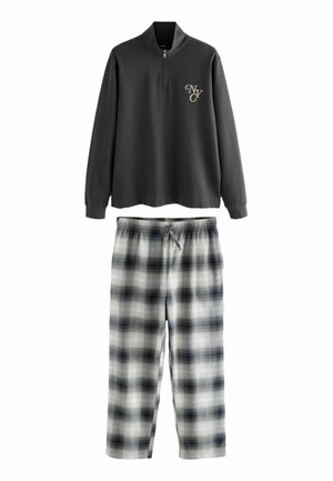 Gray zip-up sweatshirt with a logo, paired with plaid pajama pants in white and navy. The fabric is soft with an elastic waistband and drawstring.