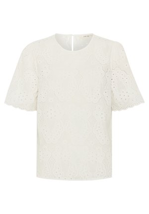 Bijela bluzica s vezom i kratkim rukavima, s okruglim izrezom i dekorativnim izrezanim uzorcima po cijeloj površini. Otvor na leđima ostaje jednostavan.