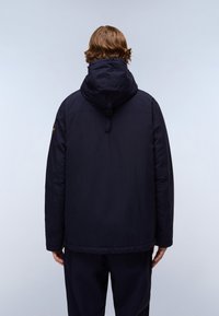 Navy blue, hooded jacket with a smooth texture, featuring a rear buckle detail and a logo patch on the left shoulder.