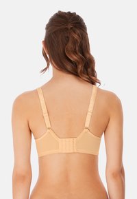 Beige bra featuring adjustable straps, a hook-and-eye closure, and smooth fabric. The design emphasizes comfort and support.