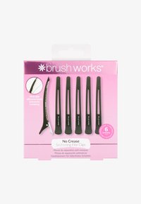 Set med sex svarta hårklämmor med en halkfri silikonrem för att förhindra veck, visade på en rosa förpackningsbakgrund.