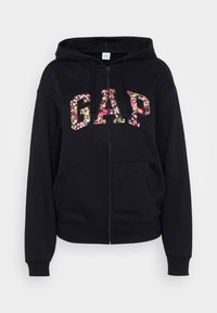 Črn zip-up kapucar z cvetličnim logotipom "GAP". Ima kapuco, kengurujčke žepke in ribane manšete. Narejen je iz mehke bombažne mešanice.
