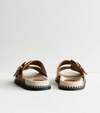 Sandalias de cuero marrón con diseño abierto, plantilla de tela y suela negra con costuras blancas. Los acentos de hebilla añaden detalle.