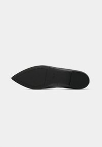 Black high-heeled shoe with a pointed toe. The sole is smooth with a slightly textured finish, featuring embossed size and brand details.