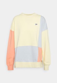 Bluza z blokami kolorów w miękkim żółtym, niebieskim i brzoskwiniowym. Posiada okrągły dekolt, długie rękawy oraz małe logo na piersi. Wykonana z bawełny.