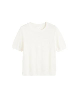 Pull blanc à manches courtes et col rond, fabriqué en tissu maille doux avec une coupe légèrement ample et des fentes latérales à l'ourlet pour une meilleure respirabilité.