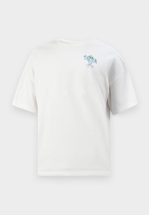 Balta medvilnė t-shirt su trumpomis rankovėmis, su mažo mėlyno animacinio personažo dizainu kairiajame krūtinės šone. Klasikinis kirpimas, lygus paviršius.