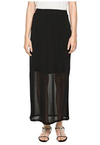 Svart maxi kjol med ett genomskinligt overlay och elastisk midja. Tyget är lätt och flödar ner till anklarna, med en lagerdesign.