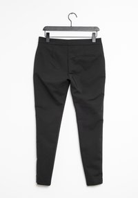 Black trousers with a fitted design, featuring a single back pocket, smooth fabric, and a sewn hem. Hang on a black plastic hook.