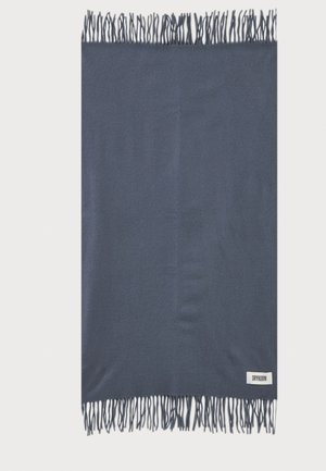 Écharpe rectangulaire bleu foncé avec bords frangés et une petite étiquette blanche indiquant "DRYKORN" dans le coin inférieur droit.