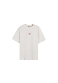 Tricou crem cu mânecă scurtă, fabricat din bumbac. Prezintă un mic logo roșu pe piept, croială lejeră și decolteu rotund.