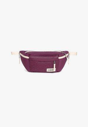 Lila Gürteltasche mit beigen verstellbaren Riemen, vorderer Reißverschlusstasche und Eastpak-Logo auf der vorderen Mitte.