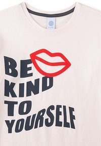 Light pink cotton t-shirt featuring bold black text: "BE KIND TO YOURSELF" and a red lip graphic. Crew neck design with short sleeves.