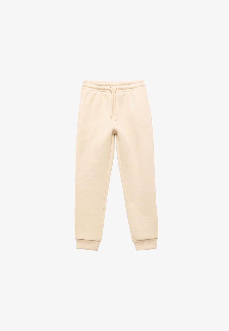 Beige katoenen joggingbroek met een trekkoord in de taille, ribben bij de boorden en zijzakken. Zachte textuur, tapered fit, minimalistisch ontwerp.