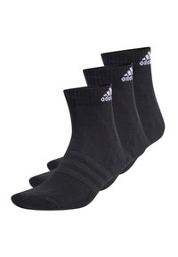 Schwarze Knöchelsocken mit geripptem Textur, bestehend aus drei Paaren. Jede Socke hat drei dünne horizontale Streifen und ein weißes Logo an der Seite.