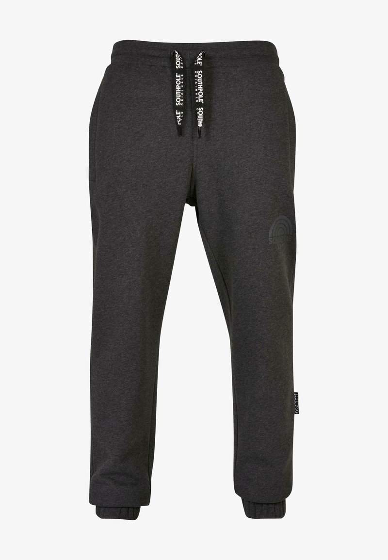 Donkergrijze sweatpants van zachte stof, met een elastische tailleband met zwarte trekkoorden en geribde manchetten. Logo afgedrukt op het been.