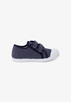 Navy canvas shoe with white rubber toe cap, featuring two adjustable Velcro straps and textured side panels for grip and comfort.