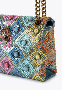 Decorative handbag featuring a diamond pattern with multicolored beads and studs, metallic chain strap, and textured fabric surface.