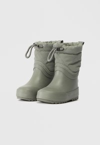 Bottes de cheville vertes imperméables avec une tige en textile matelassé, un cordon de serrage élastique et une semelle en caoutchouc à motifs pour une meilleure traction.