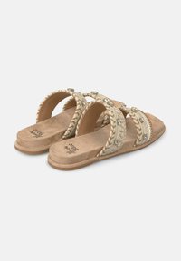 Sandali piatti open-toe con una morbida base in suede color tan, caratterizzati da tre cinghie intrecciate decorate con piccole gemme trasparenti.