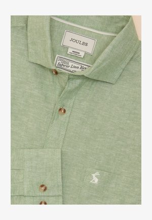Light green linen blend shirt with a button-down collar, featuring a front pocket and a small white logo. Brown buttons for closure.