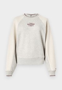 Grey sweatshirt with a textured cream accent on sleeves, ribbed cuffs, and hem. Features "Tommy Hilfiger" logo in burgundy.