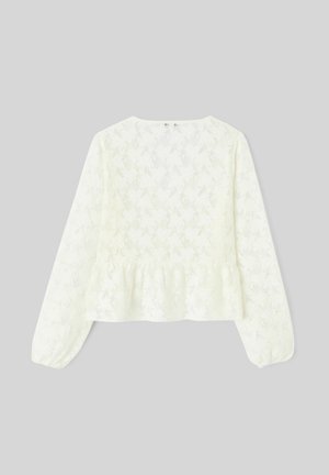 Blouse blanche à manches longues en dentelle avec motif floral et ourlet péplum, présentée à plat sur un fond gris.