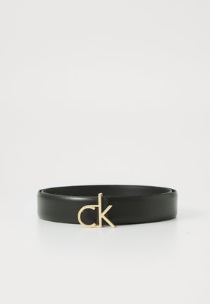 Must mustra nahkööv, millel on kuldne "ck" logo pandla. Rihm on sileda tekstuuriga ja sellel on lihtne, voolav disain.