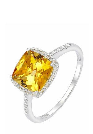 Padi lõigatud kollase vääriskiviga sõrmus hõbedasest varrukaosast, mille servadel on väikesed teemandid särava efekti lisamiseks.