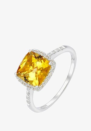 Padi lõigatud kollase vääriskiviga sõrmus hõbedasest varrukaosast, mille servadel on väikesed teemandid särava efekti lisamiseks.