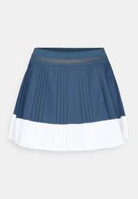 Jupe de sport plissée de couleur bleu foncé avec une bande inférieure blanche. Comprend une taille élastique et un tissu lisse et texturé.