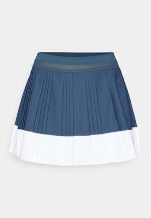 Pleated athletic skirt in dark blue with a white lower stripe. Features an elastic waistband and a smooth, textured fabric.