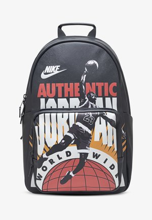 Schwarzer Rucksack mit einer Grafik eines Basketballspielers, Logo und fettem Text. Glatte Textur, Farben Rot, Weiß, Orange und Schwarz. Mit Reißverschlusstasche ausgestattet.